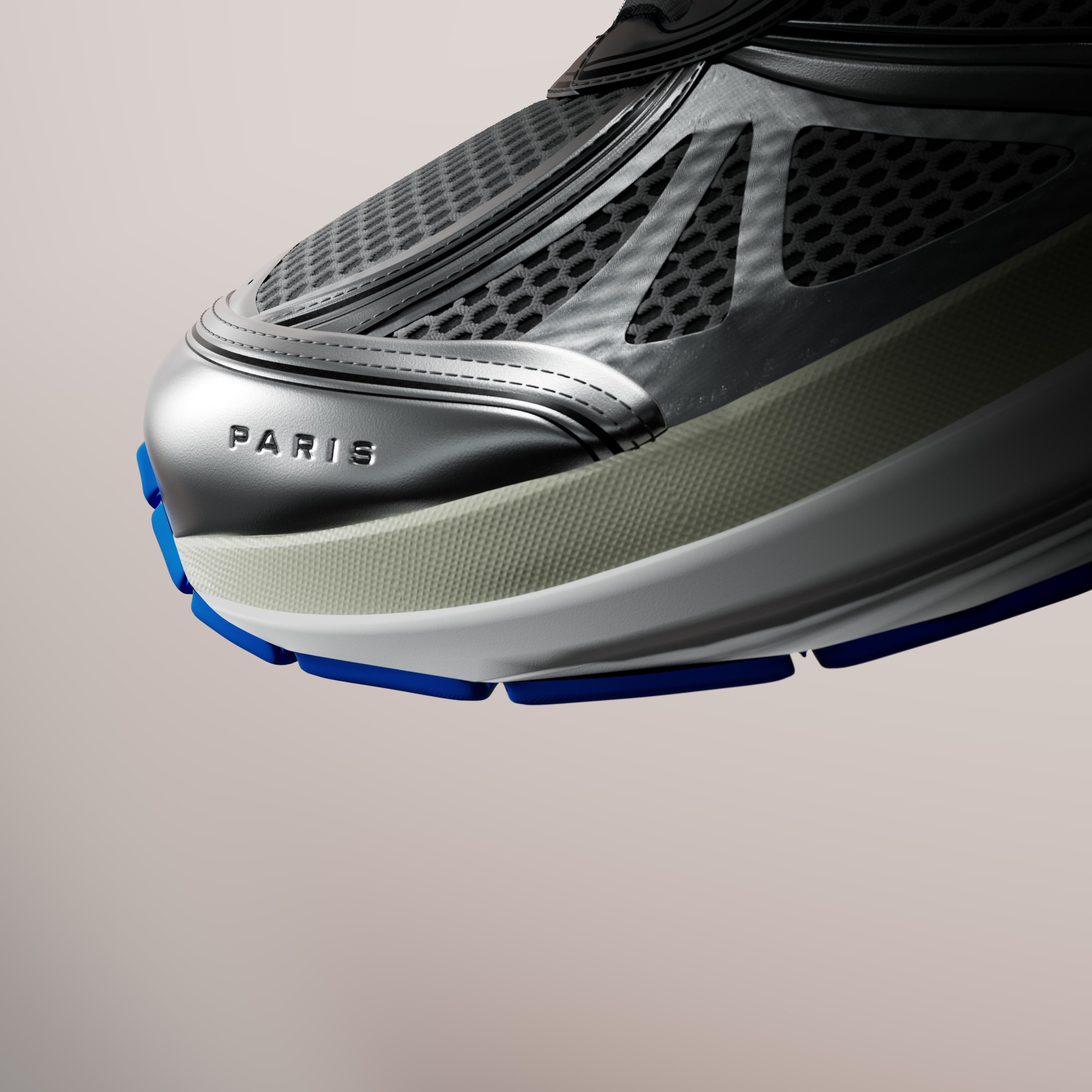 Close-up of a floating shoe's toe: dark mesh, a silver overlay embossed with the word PARIS, and a blue-edged sole, on a soft beige background.
