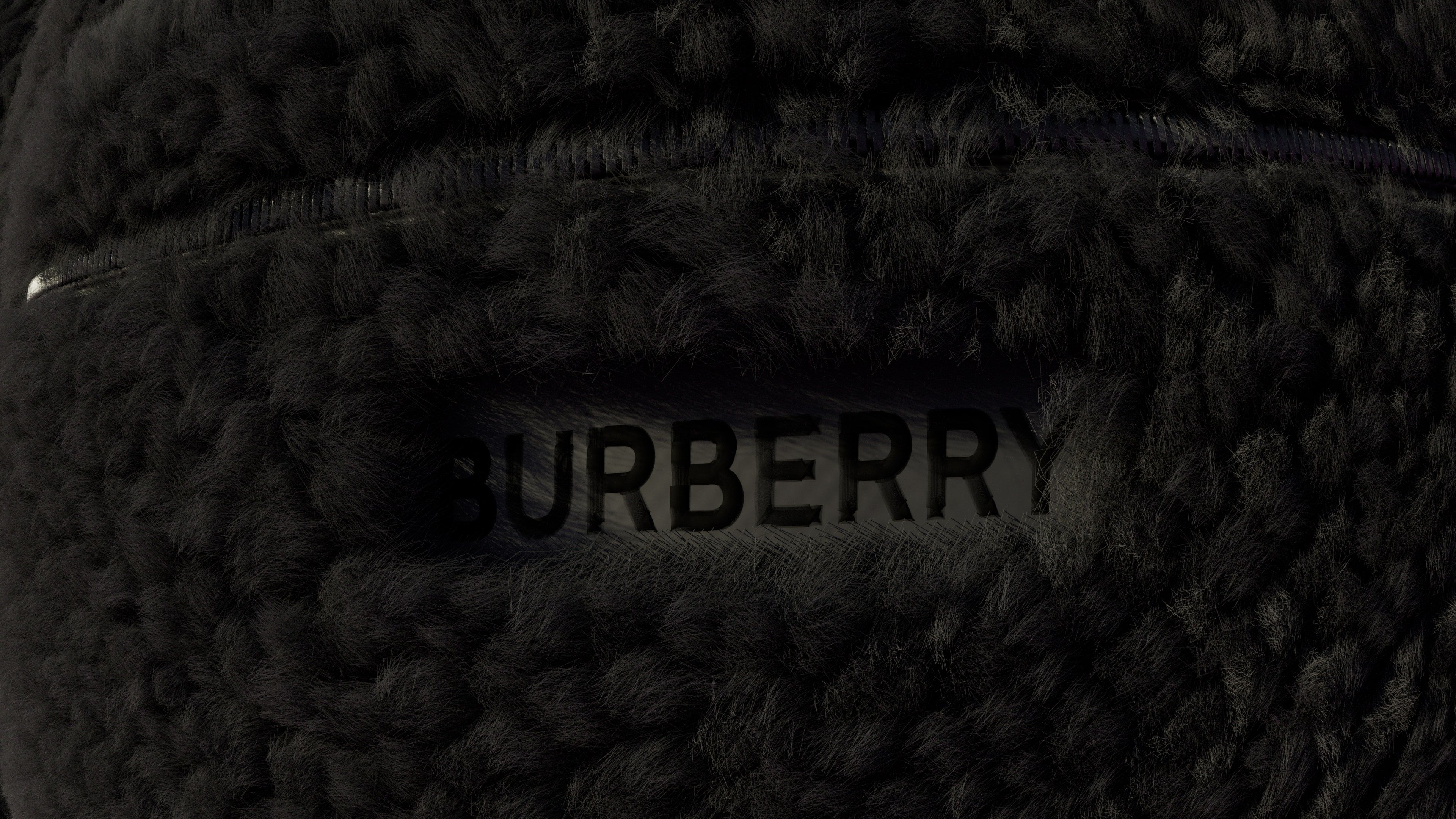 Dark close-up of the black fleece around a BURBERRY label.