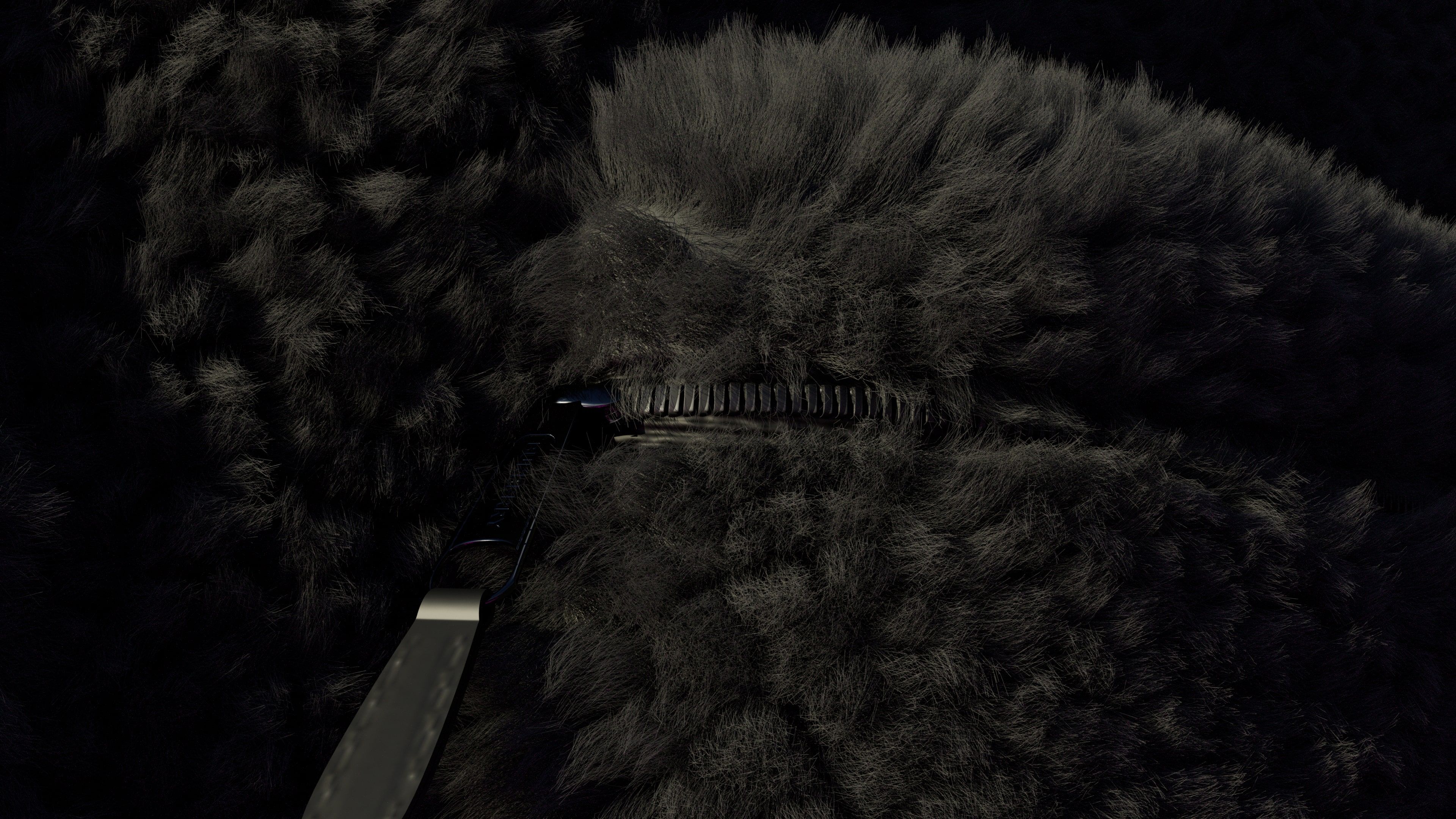 Dark close-up of the black fleece around a zip and a hanging pull tab.