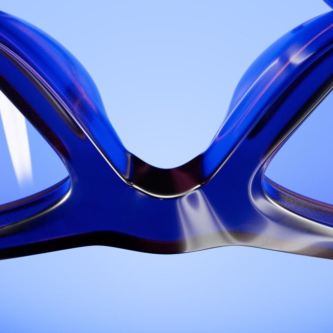 Close-up of the bridge of a glossy blue frame, against a pale blue background.